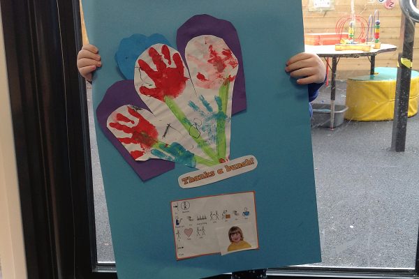 Year 2 pupil showing her handprint flowers
