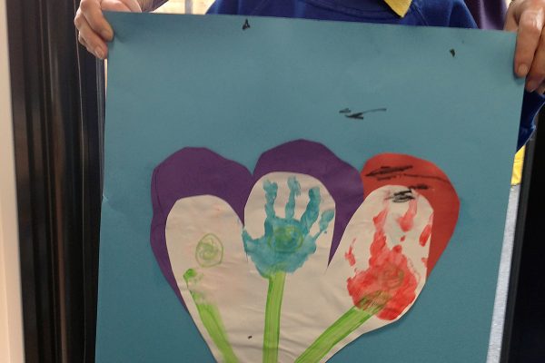 Pupil showing their handprint picture